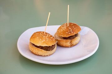 Close-up photo of a typical tapa from a Spanish bar, two burgers.