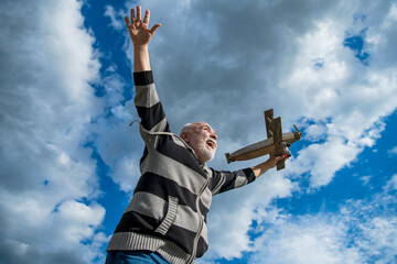 having fun. senior retired man. mature man at retirement. old man on sky background with toy plane