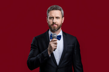 tuxedo man presenter with microphone. photo of man presenter in tuxedo hold microphone.