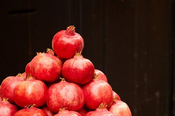Pomegranate fruits. Red tropical fruit. Stack of ripe pomegranates