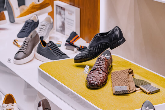 25 July 2022, Munster, Germany: Fashionable and vintage classic male shoes in the footwear shop window
