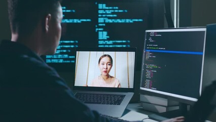 Asian man developer programmer, software engineer, IT technical support center talking with team via video call. Working on computer overtime to check coding in bugging system