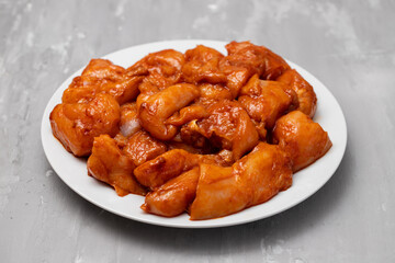 Marinating meat with spices and onion on plate