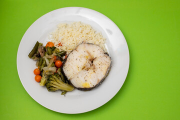 baked vegetables with boiled fish on white plate