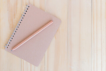 Notebook and pencil on white background.