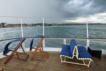 deckchair seat on the stern of a steamboat cruising on Lake Geneva, Switzerland