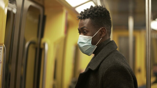 Black Man Exiting Subway Wagon. Person Commuting Underground Wearing Coronavirus Face Mask