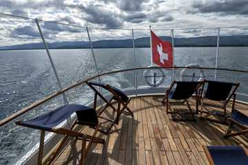 Swiss flag at the stern of a steamer cruising on Lake Geneva, Switzerland