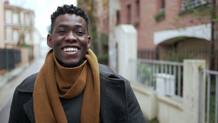 Black man celebrating success raising fist in the air. Successful African guy walking in city2