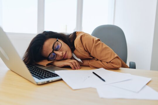 Woman business works in the office at the desk sleeps at work, fall depression, vitamin deficiency, fatigue at work