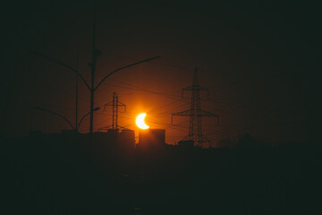 Solar eclipse over the city before sunset vintage filter Russia Novosibirsk 2022 October 25 