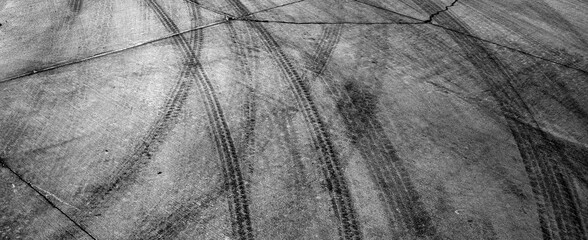 Black Tire Tracks Marks on Cement Drive