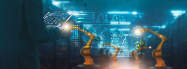 Industry engineer in factory,using smart tablet glass device,control automated robot arm machine learning operation,concept business and industry 4.0,Artificial intelligence or AI,with 5G network