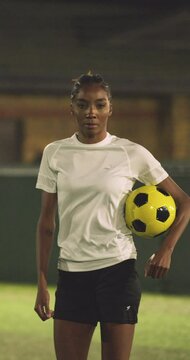 Portrait of female soccer player in soccer field at night