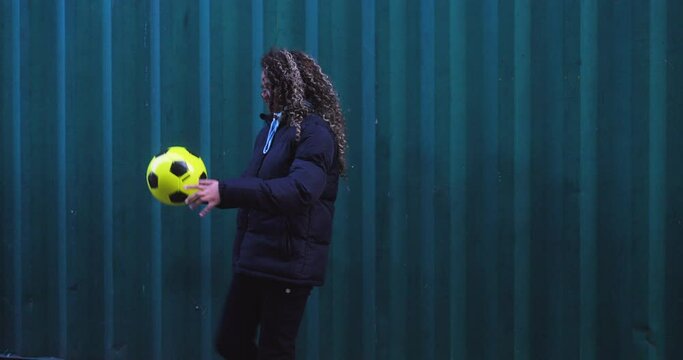 Smiling woman bouncing soccer ball