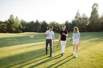 friends on golf court talking, shares his impressions after playing golf. . High quality photo