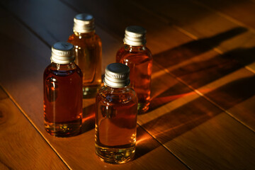 Four small glass bottles for a whisky tasting
