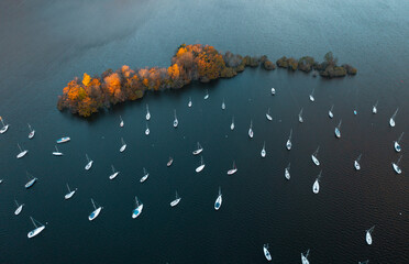 Boats on a lake during autumn, warm morning sun. Lake Windermere Marina. Boats on Lake Windermere	

