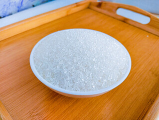 White sugar canesugar crystals granulated made from sucrose of sugarcane  sweet product artificial sweeteners shakar cheeni food ingredient in a bowl closeup view image stock photo selective focus