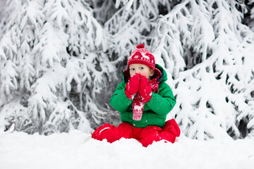 Boy on sleigh ride. Child sledding. Kid with sledge