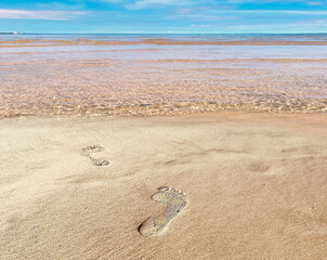 footprints on the sand by the sea blue sky summer nature landscape seascape 