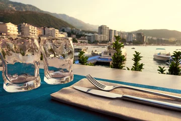 Foto op Canvas Coffee table on the sea coast ready for dinner © serebryannikov