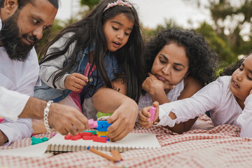 Happy indian family having playful time at city park
