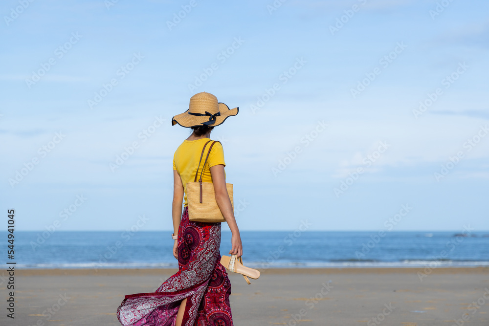 Wall mural travel woman walk on the beach at kinmen of taiwan