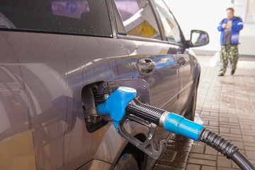 Refueling a car with fuel at a gas station.