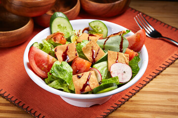 Fresh Fattoush Salad with tomato, cucumber and green leaf served in bowl isolated on table side view of middle east food