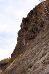 A sheer cliff on the Ishim River. Natural relief. Autumn landscape.