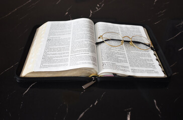 Open bible with glasses