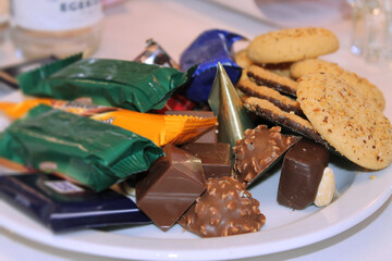 Plate with homemade cookies, chocolate and sweets for dessert