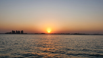 beautiful sunset over the sea. City line of Doha, Qatar, Gulf region