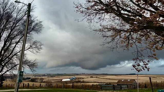 Enhanced footage of dark  storm clouds rolling over Midwestern hills