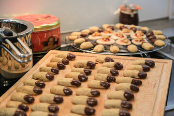 Christmas bakery: Delicious homemade hazelnut cookies for advent or christmas-freshly baked and garnished with chocolate, made with love, blurred background, close up