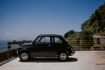 Fototapeta na wymiar car on the road, Italian car, cinquecento, blu car on the sea