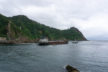 Ship being dragged out to sea in Pasaia Spain