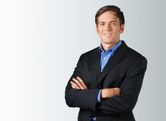 Happy handsome young male posing hands folded