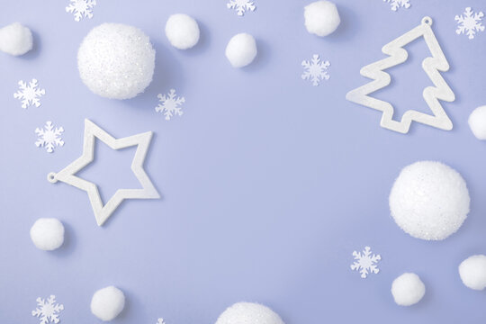 Christmas composition. White balls, snowflakes, gifts and Christmas trees on a purple pastel background