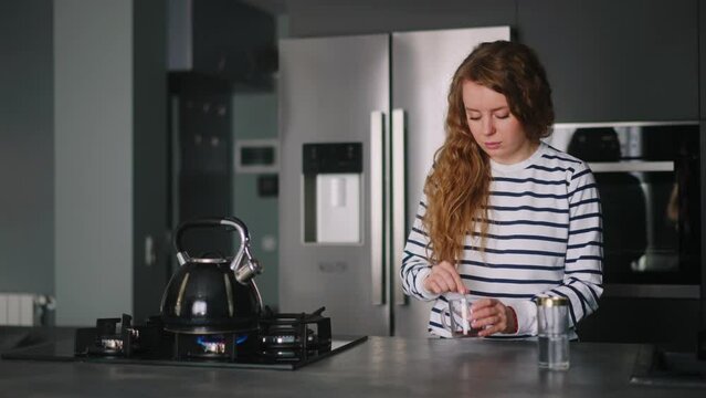 Close up - woman has a heart attack doing coffee, taking pills. Adult female boiling water, feels pain in her chest, takes medicine. Girl cooking dinner and experiences pain in heart, drinks drugs.