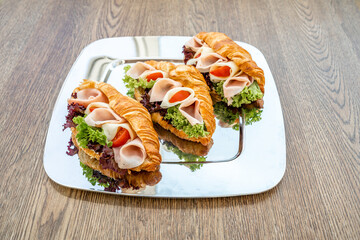Croissant filled with ham, cheese and vegetables