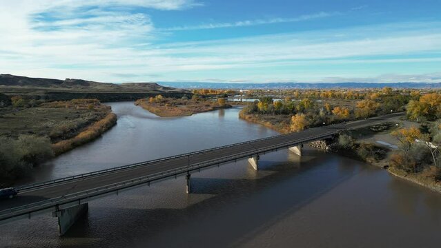 Aerial above highway bridge over Colorado River through Grand Junction, Colorado in autumn