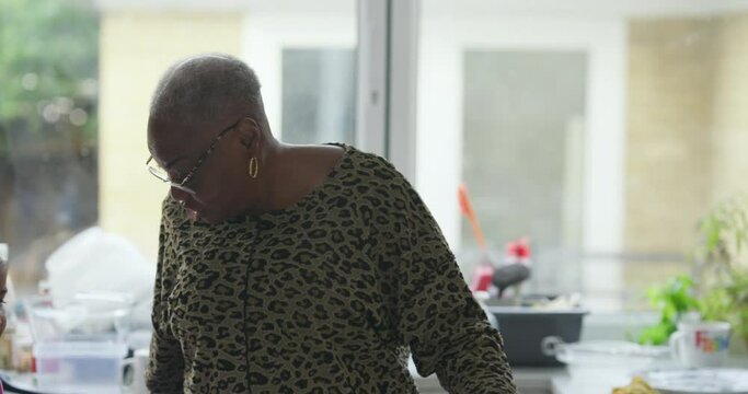 Senior woman with granddaughter cooking in kitchen