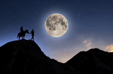  The rider silhouette and his friend's walk in the starry night under full moon.