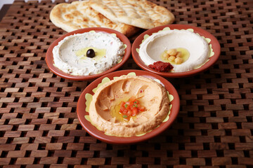 mixed hummus with bread served in dish isolated on table side view of middle east food