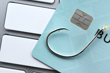 Phishing email scam fraud identity theft - credit card fishing hook blank computer keyboard for mock up 