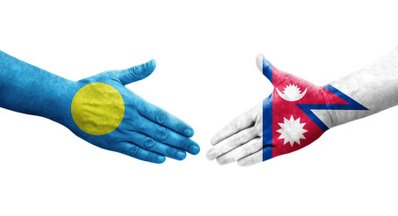 Handshake between Nepal and Palau flags painted on hands, isolated transparent image.