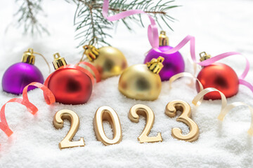 Happy New Year 2023 background, new year holidays card with balls on the snow.