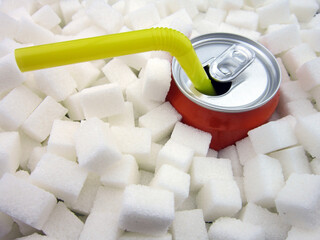Carbonated soda drink with many sugar cubes. Unhealthy eating concept.